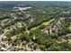 An aerial view showcases the neighborhood's lush greenery and the home's prime location near the golf course at 1348 Bridgemill Ave, Canton, GA 30114