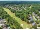Scenic aerial view of the neighborhood golf course surrounded by mature trees and beautiful homes at 1348 Bridgemill Ave, Canton, GA 30114