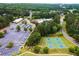 Aerial view showcasing community amenities including pool, clubhouse, tennis courts, and parking at 1348 Bridgemill Ave, Canton, GA 30114