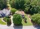 Aerial view of house featuring a manicured lawn, established trees and fence at 1348 Bridgemill Ave, Canton, GA 30114