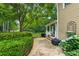 Landscaped backyard with patio, flowers, trees and a manicured lawn on a sunny day at 1348 Bridgemill Ave, Canton, GA 30114
