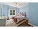 Cozy bedroom with blue walls, a window with curtains, and a decorative iron bed frame at 1348 Bridgemill Ave, Canton, GA 30114