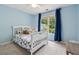 Cozy bedroom with plush carpet, large windows, blue drapes and a white bed frame at 1348 Bridgemill Ave, Canton, GA 30114