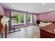 Bright bedroom with lavender walls, wood-look flooring, large windows, and white trim at 1348 Bridgemill Ave, Canton, GA 30114