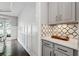 Hallway features a butler's pantry and access to the dining room with hardwood floors and lots of natural light at 1348 Bridgemill Ave, Canton, GA 30114