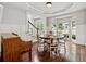 Dining room featuring lots of windows for natural light, hardwood floors, and access to the staircase and entry at 1348 Bridgemill Ave, Canton, GA 30114