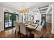 Dining room with a view to the living room fireplace and access to a rear blue-doored patio with backyard views at 1348 Bridgemill Ave, Canton, GA 30114