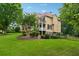 Stunning view of a two-story tan house with a luscious green lawn at 1348 Bridgemill Ave, Canton, GA 30114