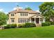 Back of the house features plentiful windows, a covered patio, and a beautifully manicured lawn at 1348 Bridgemill Ave, Canton, GA 30114