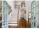 The bright foyer features a staircase and hardwood floors, creating a welcoming entrance to the home at 1348 Bridgemill Ave, Canton, GA 30114