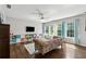 Bright living room featuring a ceiling fan, hardwood floors, large windows and built in bookshelves and storage at 1348 Bridgemill Ave, Canton, GA 30114