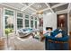Elegant living room boasts coffered ceilings, hardwood floors, a fireplace and abundant natural light from large windows at 1348 Bridgemill Ave, Canton, GA 30114