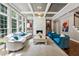 Elegant living room boasts coffered ceilings, hardwood floors, a fireplace and abundant natural light from large windows at 1348 Bridgemill Ave, Canton, GA 30114