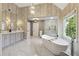 Luxurious main bathroom with double vanity, tub, standing shower and modern finishes at 1348 Bridgemill Ave, Canton, GA 30114