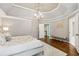 Spacious main bedroom featuring decorative walls, a tray ceiling, and a modern light fixture at 1348 Bridgemill Ave, Canton, GA 30114