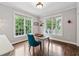 Bright office features hardwood floors, two windows, and a stylish blue chair at a gray desk at 1348 Bridgemill Ave, Canton, GA 30114