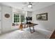Inviting office space with a guitar, natural light, neutral walls, carpeted floor, and an appealing, rustic desk at 1348 Bridgemill Ave, Canton, GA 30114