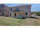 Backyard features a covered patio and expansive lawn at 281 Chiswick Loop, Stockbridge, GA 30281