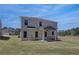Backyard features a covered patio and expansive lawn at 281 Chiswick Loop, Stockbridge, GA 30281
