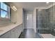 Bathroom boasts double sink vanity, tiled shower, and tile flooring at 281 Chiswick Loop, Stockbridge, GA 30281