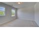 Serene bedroom featuring two windows, neutral carpet and lots of natural light at 281 Chiswick Loop, Stockbridge, GA 30281