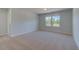 Comfortable bedroom with neutral carpet, natural lighting, and a serene ambiance at 281 Chiswick Loop, Stockbridge, GA 30281