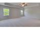 Large, naturally-lit main bedroom featuring tray ceiling, ceiling fan, and plush carpet at 281 Chiswick Loop, Stockbridge, GA 30281