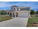 Beautiful two-story home featuring a spacious driveway and a well-manicured lawn at 281 Chiswick Loop, Stockbridge, GA 30281