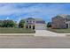 Two-story home with a two-car garage, a well-manicured lawn, and a concrete driveway at 281 Chiswick Loop, Stockbridge, GA 30281