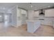 Bright, open kitchen features white cabinets, stainless steel appliances, and a central island with pendant lighting at 281 Chiswick Loop, Stockbridge, GA 30281