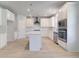 Modern kitchen featuring white cabinets, stainless steel appliances, and a center island at 281 Chiswick Loop, Stockbridge, GA 30281