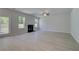 Spacious living room with lots of natural light and a fireplace, with access to the outside at 281 Chiswick Loop, Stockbridge, GA 30281