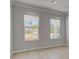 Bright living room with large windows, neutral walls, and hardwood floors at 281 Chiswick Loop, Stockbridge, GA 30281