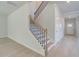 Elegant staircase with hardwood steps and decorative railings at 281 Chiswick Loop, Stockbridge, GA 30281