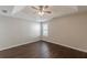 Bedroom featuring a tray ceiling and window with hardwood flooring and neutral paint at 363 Chadwick Cmn, Stockbridge, GA 30281