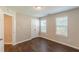 This bedroom has laminate floors and two windows letting in lots of natural light at 363 Chadwick Cmn, Stockbridge, GA 30281