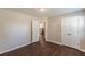 This bedroom features laminate floors, neutral walls, and an access door to the kitchen at 363 Chadwick Cmn, Stockbridge, GA 30281