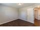 A bright bedroom featuring laminate floors and a white door is illuminated by overhead lighting at 363 Chadwick Cmn, Stockbridge, GA 30281