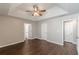 Bedroom featuring multiple doors, a ceiling fan, and a tray ceiling with hardwood flooring at 363 Chadwick Cmn, Stockbridge, GA 30281