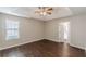 Spacious bedroom featuring a tray ceiling, ceiling fan, and window with natural light at 363 Chadwick Cmn, Stockbridge, GA 30281