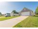 Charming single-story home featuring an attached garage and a well-manicured lawn in a peaceful neighborhood at 363 Chadwick Cmn, Stockbridge, GA 30281