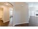 Hallway featuring hardwood floors and doorways to bathroom and other rooms at 363 Chadwick Cmn, Stockbridge, GA 30281