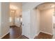 Hallway with hardwood flooring showcasing an archway entry and a door leading to a room at 363 Chadwick Cmn, Stockbridge, GA 30281