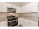 Bright kitchen featuring stainless steel appliances, white cabinets and granite countertops at 363 Chadwick Cmn, Stockbridge, GA 30281