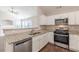 Modern kitchen featuring stainless steel appliances, granite countertops, and a view to the living area at 363 Chadwick Cmn, Stockbridge, GA 30281
