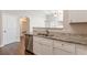 Well-designed kitchen with white cabinetry, granite countertops, and stainless steel appliances at 363 Chadwick Cmn, Stockbridge, GA 30281