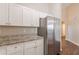Modern kitchen featuring stainless steel appliances, white cabinets, and a granite countertop at 363 Chadwick Cmn, Stockbridge, GA 30281