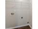 A practical laundry area offers convenience with hookups and a wire shelf for storage at 363 Chadwick Cmn, Stockbridge, GA 30281