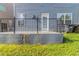 Concrete back patio, enclosed with iron railing, adjacent to home's back entry and rear windows at 4183 May Apple Ln, Atlanta, GA 30349