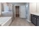 Modern bathroom featuring a separate shower, tub, and double vanity sinks at 4183 May Apple Ln, Atlanta, GA 30349